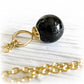 Hand blown black glass memorial marble set on a 14k gold necklace