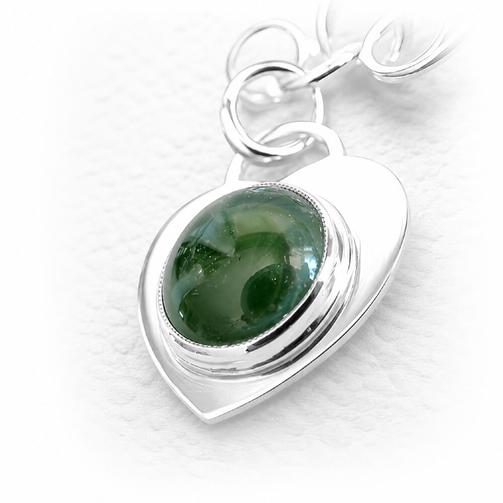Artisan crafted glass cremation cabochon set in a heart shaped sterling silver heart for a memorial charm bracelet