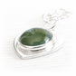 Green hand blown glass cremation cabochon set on sterling silver with cremation ashes sealed within the glass