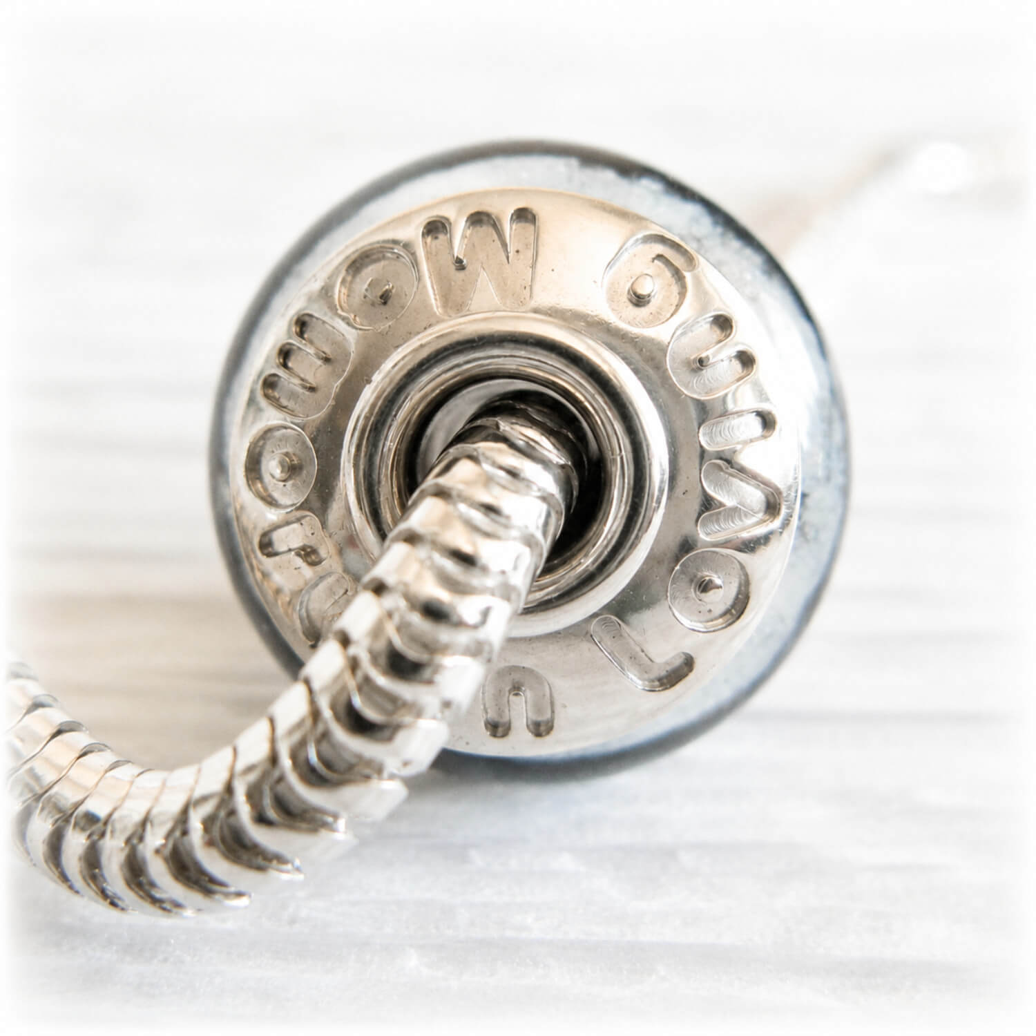 Custom engraving on a sterling silver bead cap for a memorial bead that reads 'In Loving Memory'