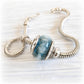 Snake chain charm bracelet with a blue memorial bead infused with a loved one ashes
