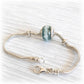 Sterling silver bracelet with a blue glass memorial bead and custom engraved silver bead caps