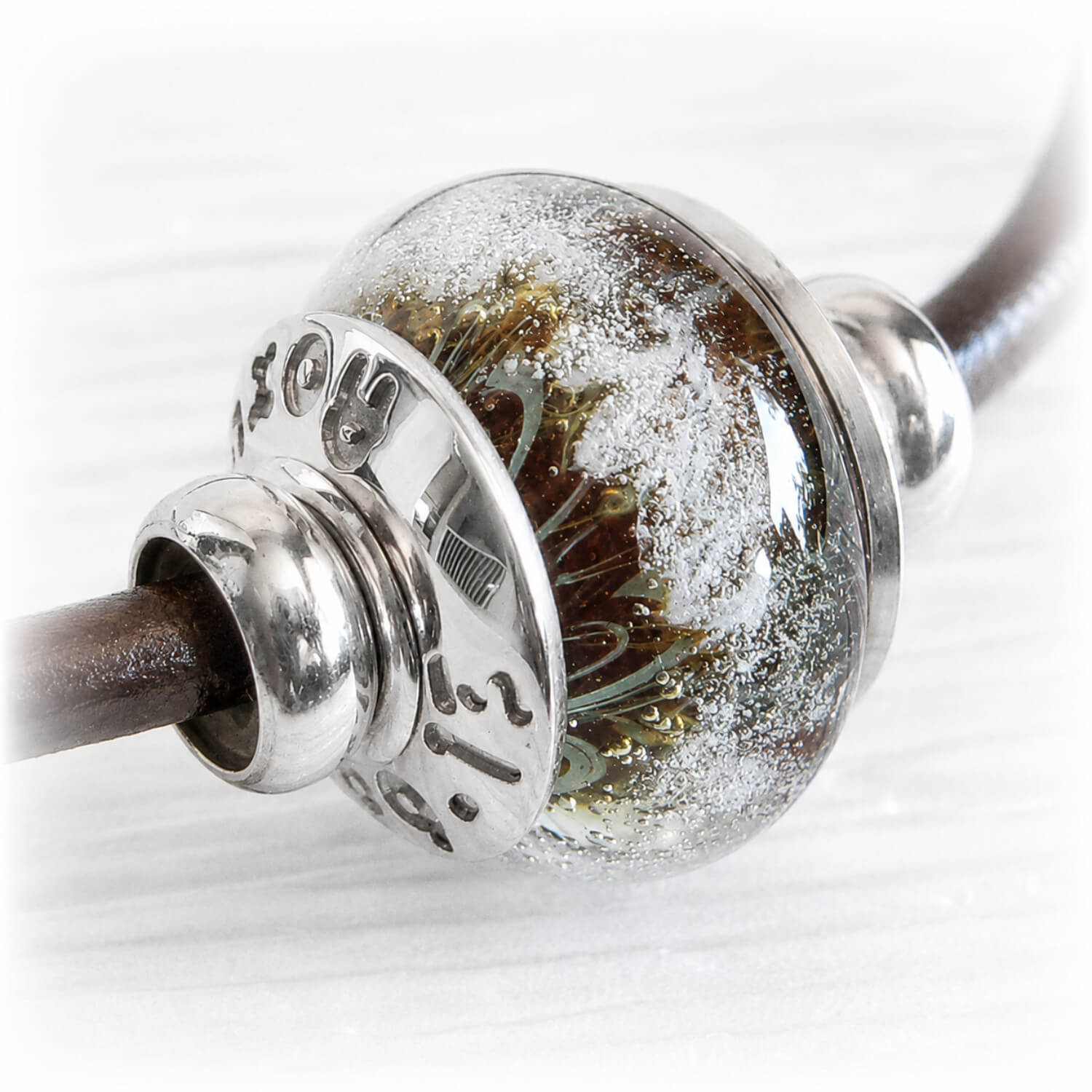 Close-up of a memorial charm bead made from hand blown glass in Arizona