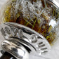 Close up of custom engraving on a hand blown glass cremation bead