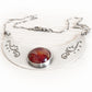 Sterling silver cremation necklace with a red hand blown glass cremation gem containing ashes sealed within the glass