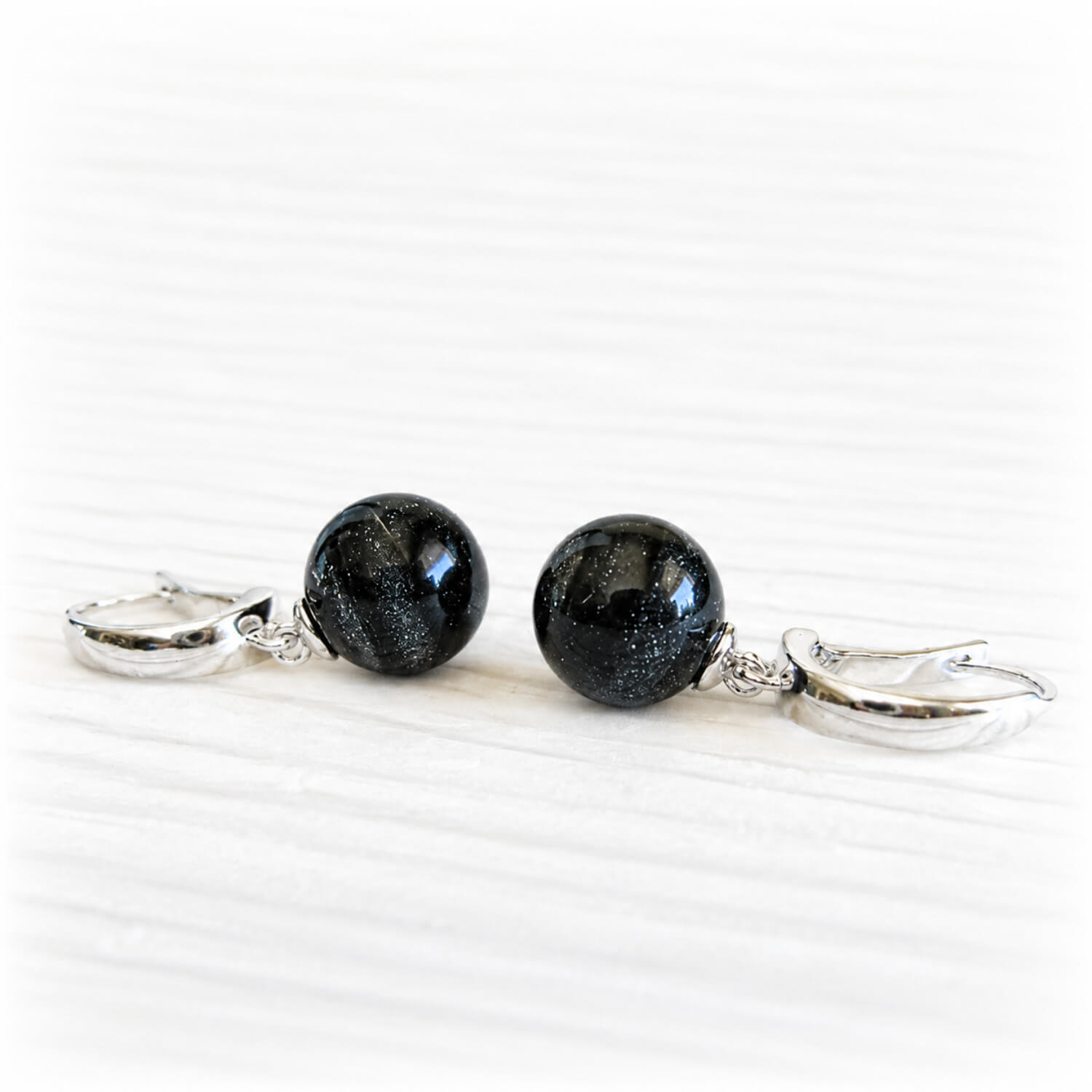 Hand blown glass earrings with black glass marbles containing cremation ashes