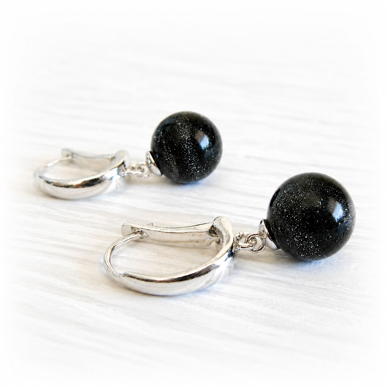 Black hand crafted ash-infused glass cremation marble earrings with quality sterling silver leaver back findings.