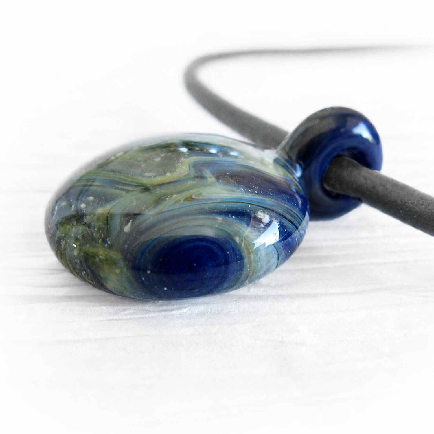Artisan made glass cremation pendant handcrafted with cremation ashes and Lapis glass 