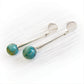 Hand blown teal glass marbles swirled with cremation ashes on sterling silver dangle earrings