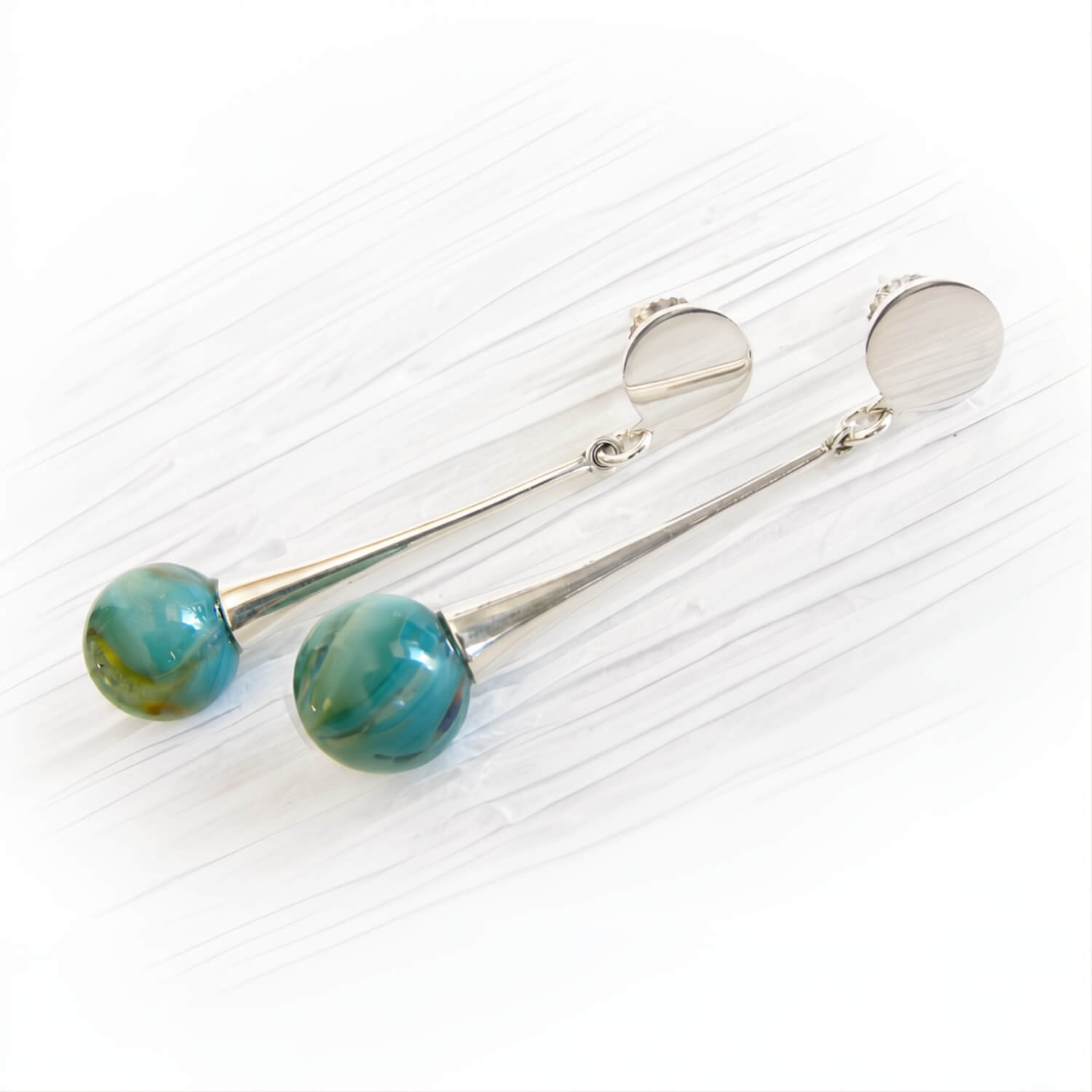 Hand blown teal glass marbles swirled with cremation ashes on sterling silver dangle earrings