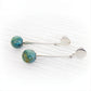 Pair of sterling silver dangle earrings featuring two small turquoise glass marbles containing cremation ashes