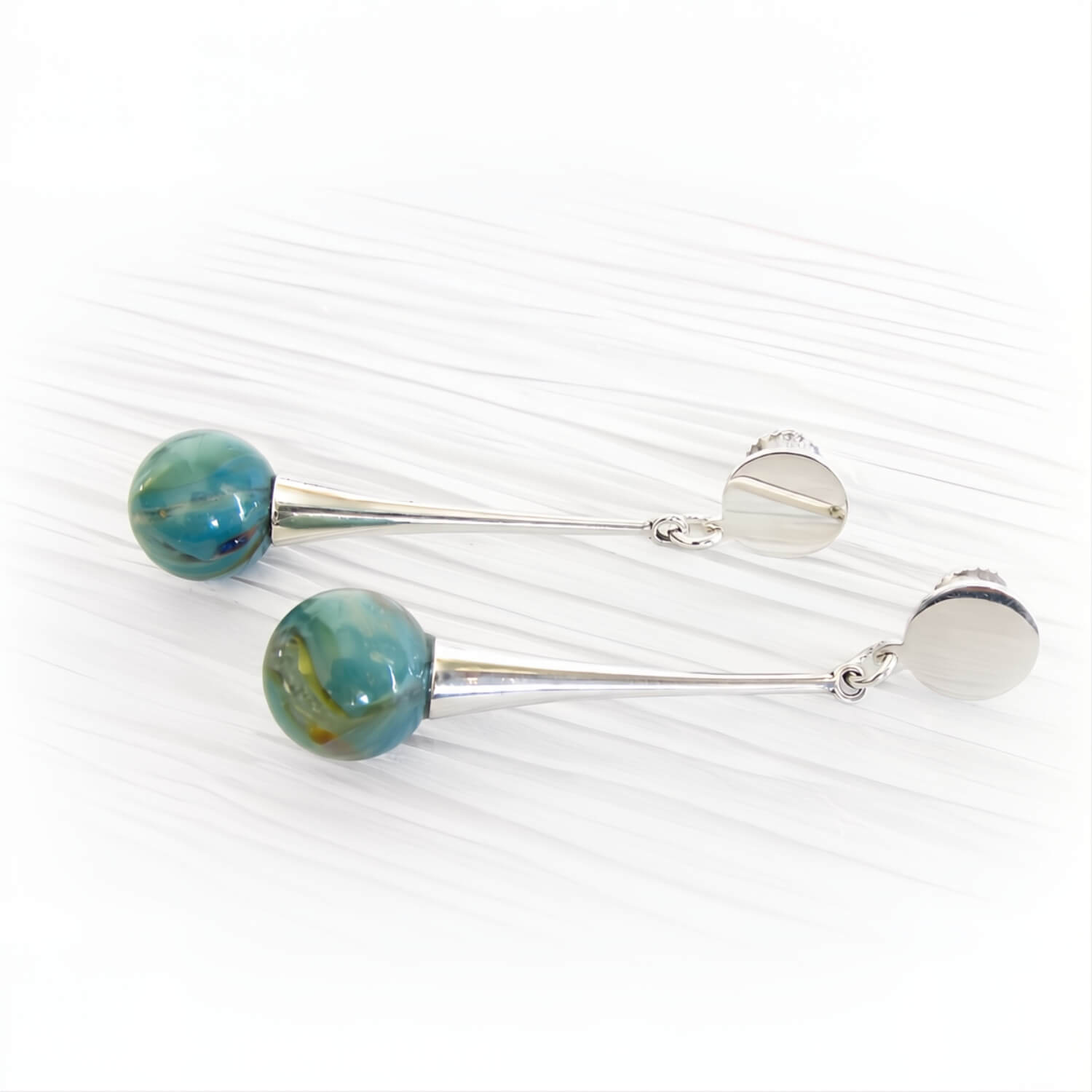 Pair of sterling silver dangle earrings featuring two small turquoise glass marbles containing cremation ashes