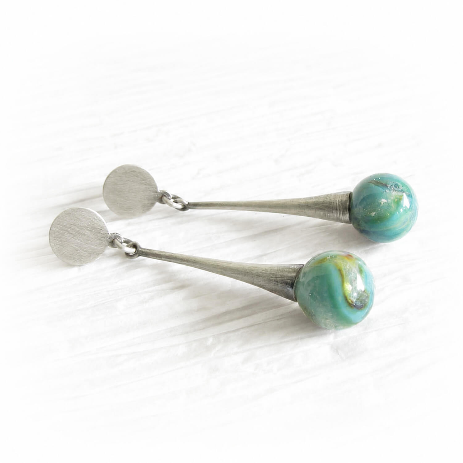 Small turquoise hand blown glass ash infused marbles set on sterling silver earrings with an antique finish 