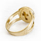 Cross cut out on the back of a solid gold memorial ring with hand blown glass containing ashes