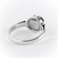 A silver ring shown from the back, featuring a polished band and a round bezel setting. The inside of the ring is stamped with 'S925', indicating sterling silver.