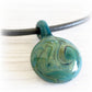 Hand blown glass memorial pendant handcrafted with cremation ashes on a black leather chord