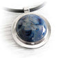 Close up of a blue artisan made cremation cabochon set in sterling silver 