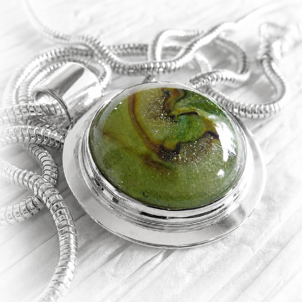 Sterling silver memorial pendant with a handcrafted ash-infused green glass cabochon