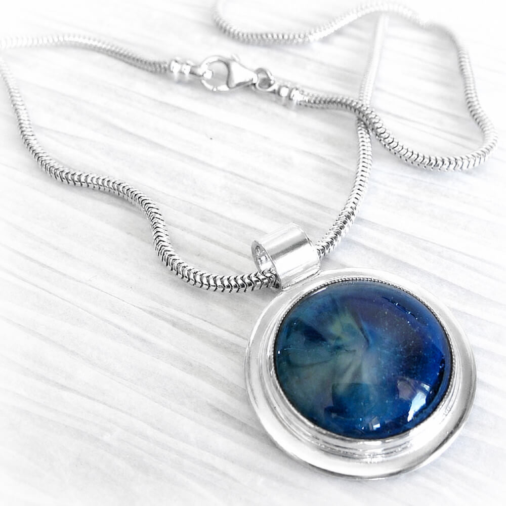 Sterling silver cremation pendant with handcrafted ash-infused blue glass cabochon