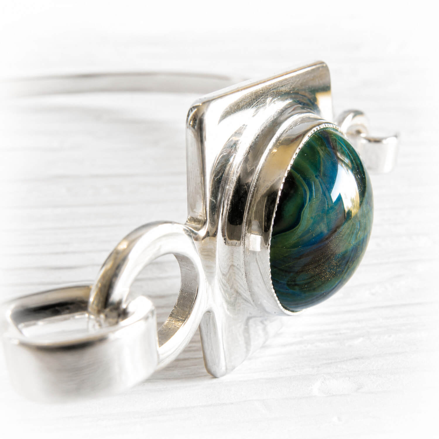 Handcrafted memorial glass infused with cremation ashes set in polished sterling silver