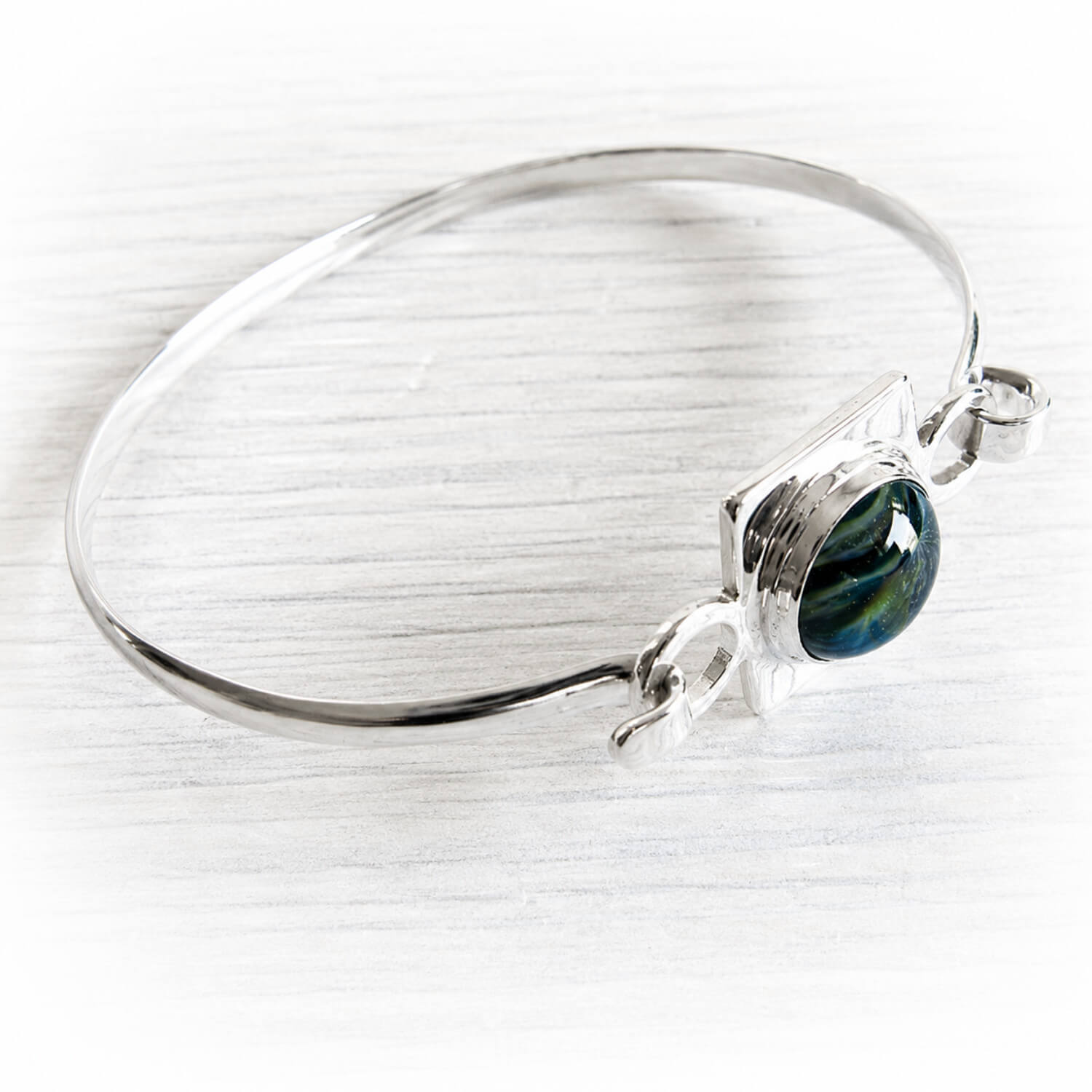 Polished sterling silver bracelet with blue and green hand blown glass containing pet ashes