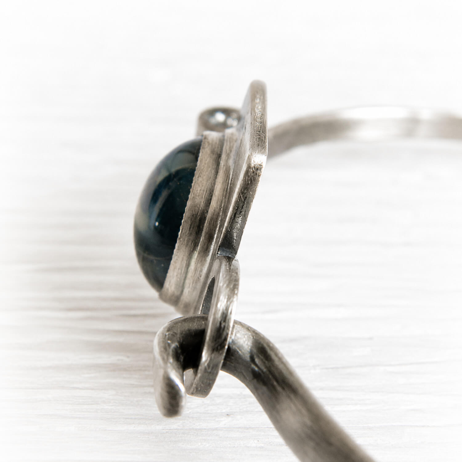 Sterling silver memorial bracelet with an antique finish featuring a glass gem infused with cremation ashes