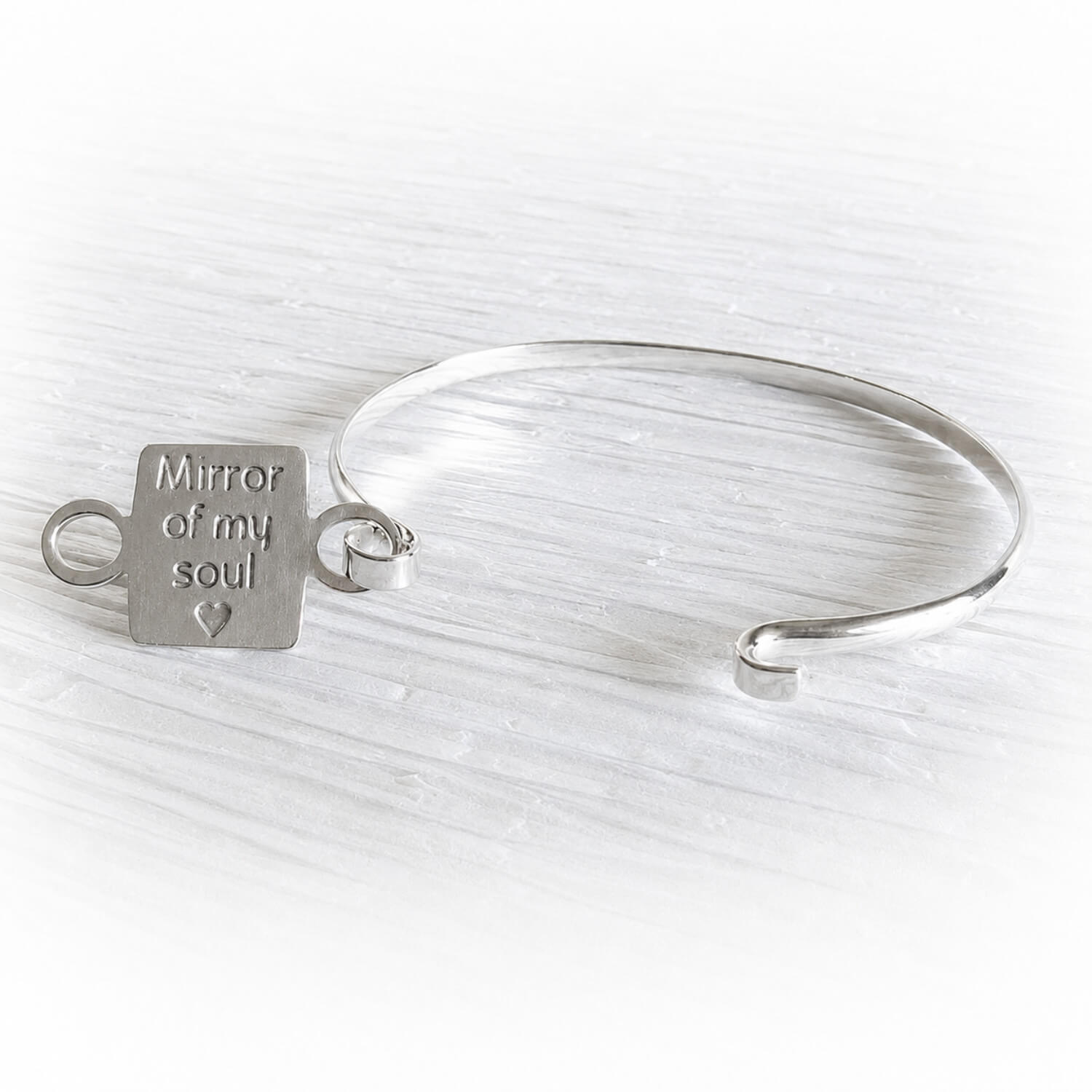 Sterling silver memorial bangle bracelet with custom engraving that says 'Mirror of my soul' on he back