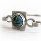Blue and green hand blown glass handcrafted with cremation ashes set into a sterling silver bracelet with an antique finish 