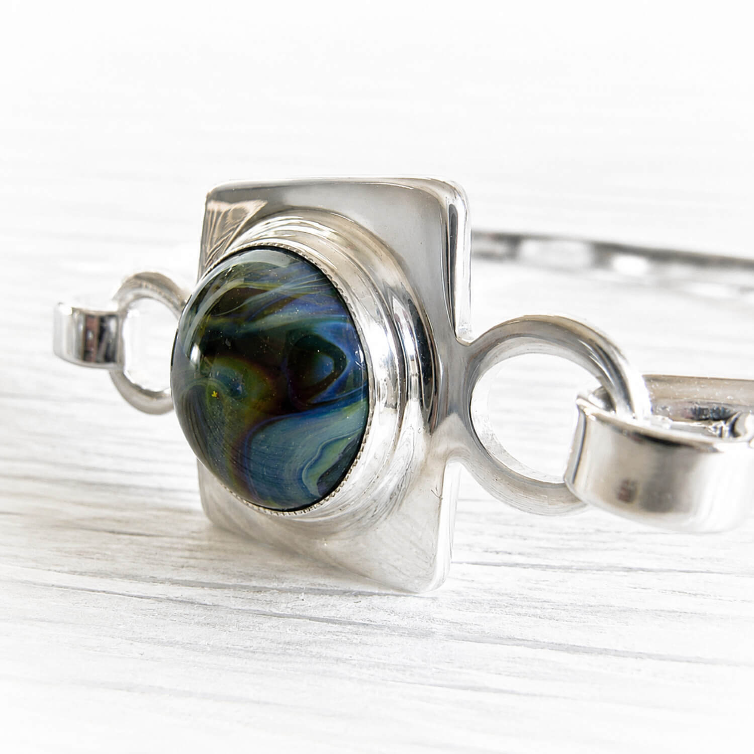 Sterling silver memorial bracelet with round, multicolored hand blown glass containing cremation ashes