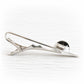 Side view of a sterling silver memorial tie bar with a black glass cabochon infused with cremation ashes