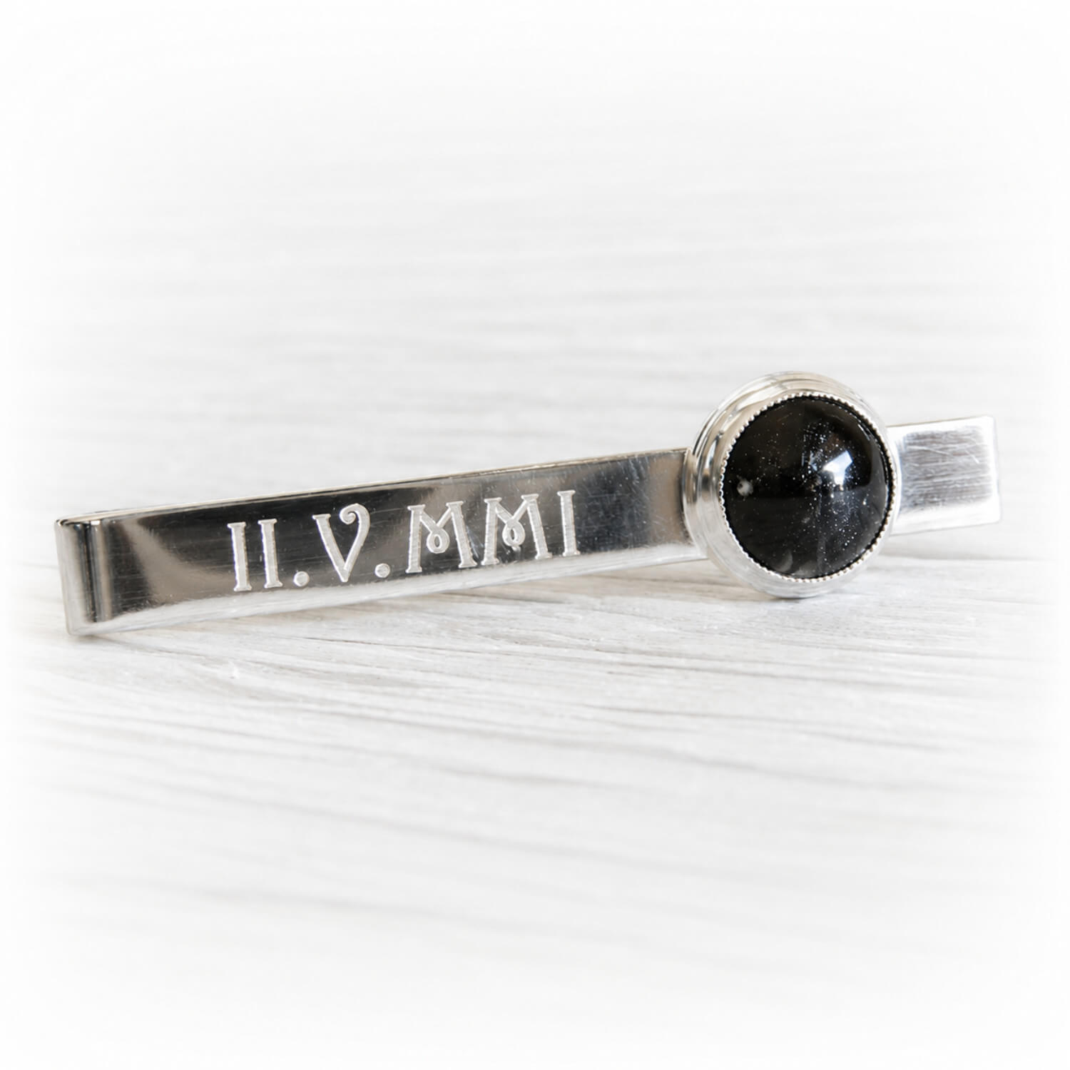 Personalized engraving on a sterling silver tie bar showcasing a hand blown  glass dome containing cremation ashes