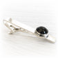 Hand blown glass memorial stone with cremation ashes set onto a sterling silver remembrance tie bar