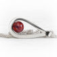 Hand forged polished sterling silver tear drop pendant featuring red glass swirled with cremation ashes