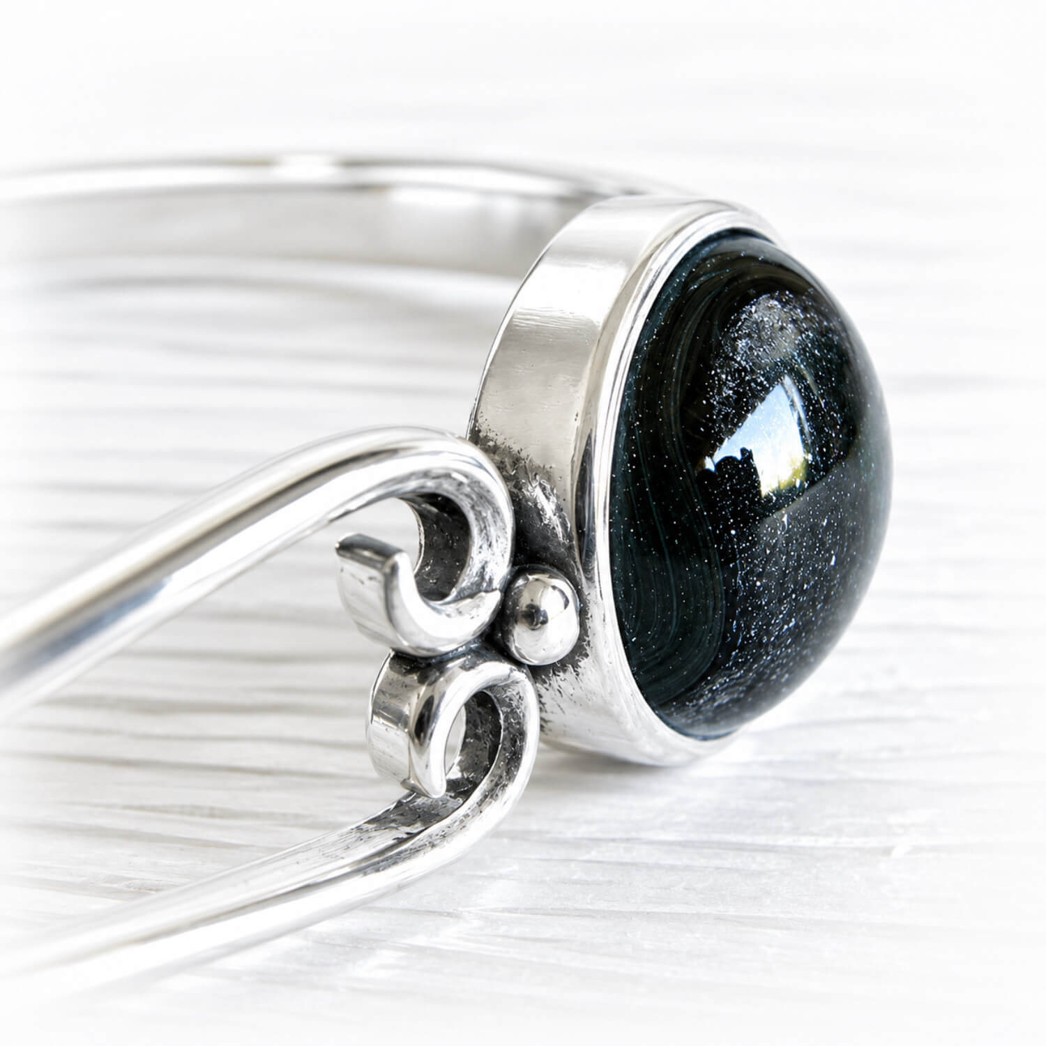 Black hand blown glass handcrafted with cremation ashes in a sterling silver memorial cuff bracelet