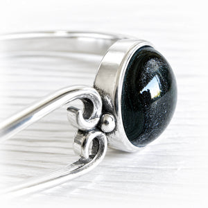 Black hand blown glass handcrafted with cremation ashes in a sterling silver memorial cuff bracelet