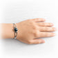 Memorial cuff bracelet featuring a hand crafted black glass cremation gem stone on the wrist of a model