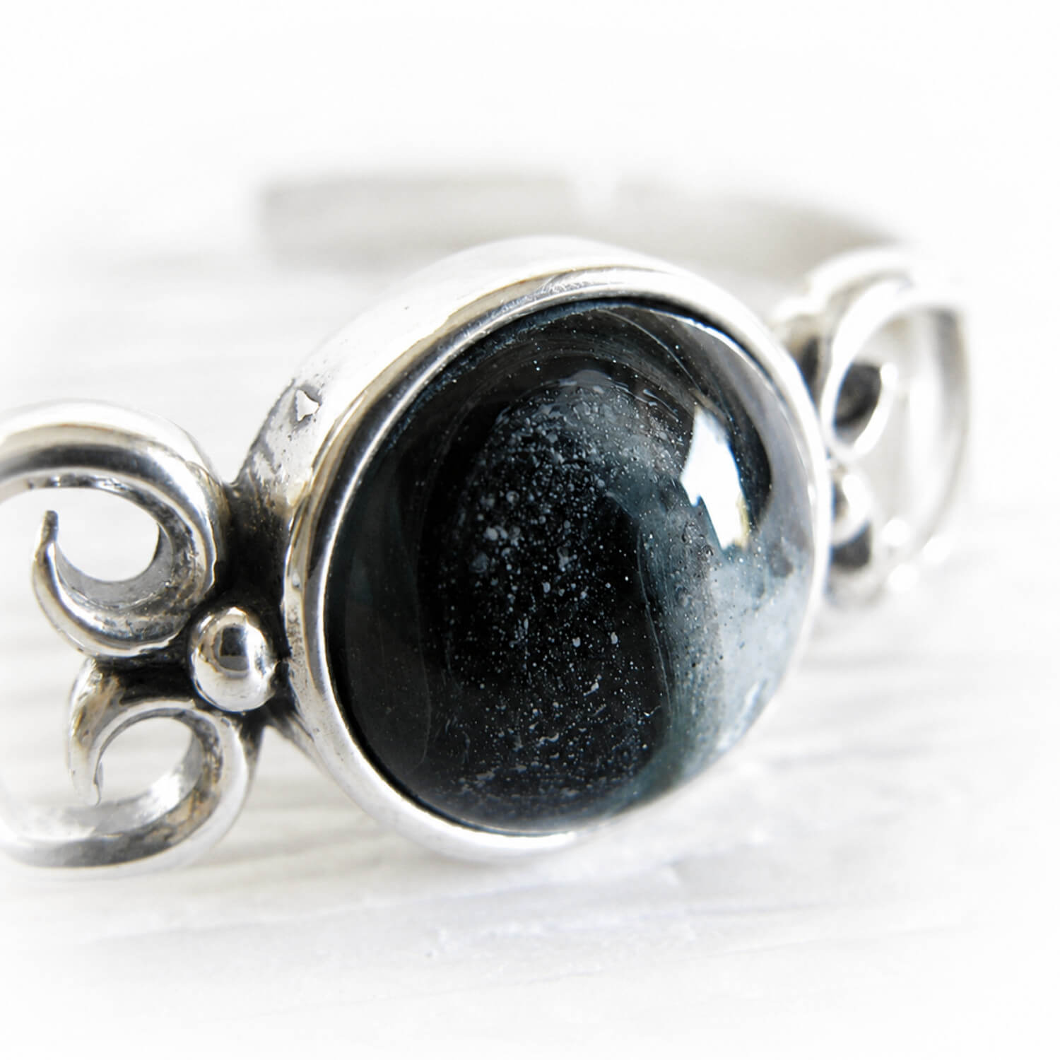 Artisan crafted black cremation glass center piece on a sterling silver cuff bracelet
