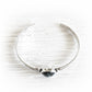 Sterling silver cuff bracelet featuring handcrafted memorial glass with cremation ashes sealed within the glass