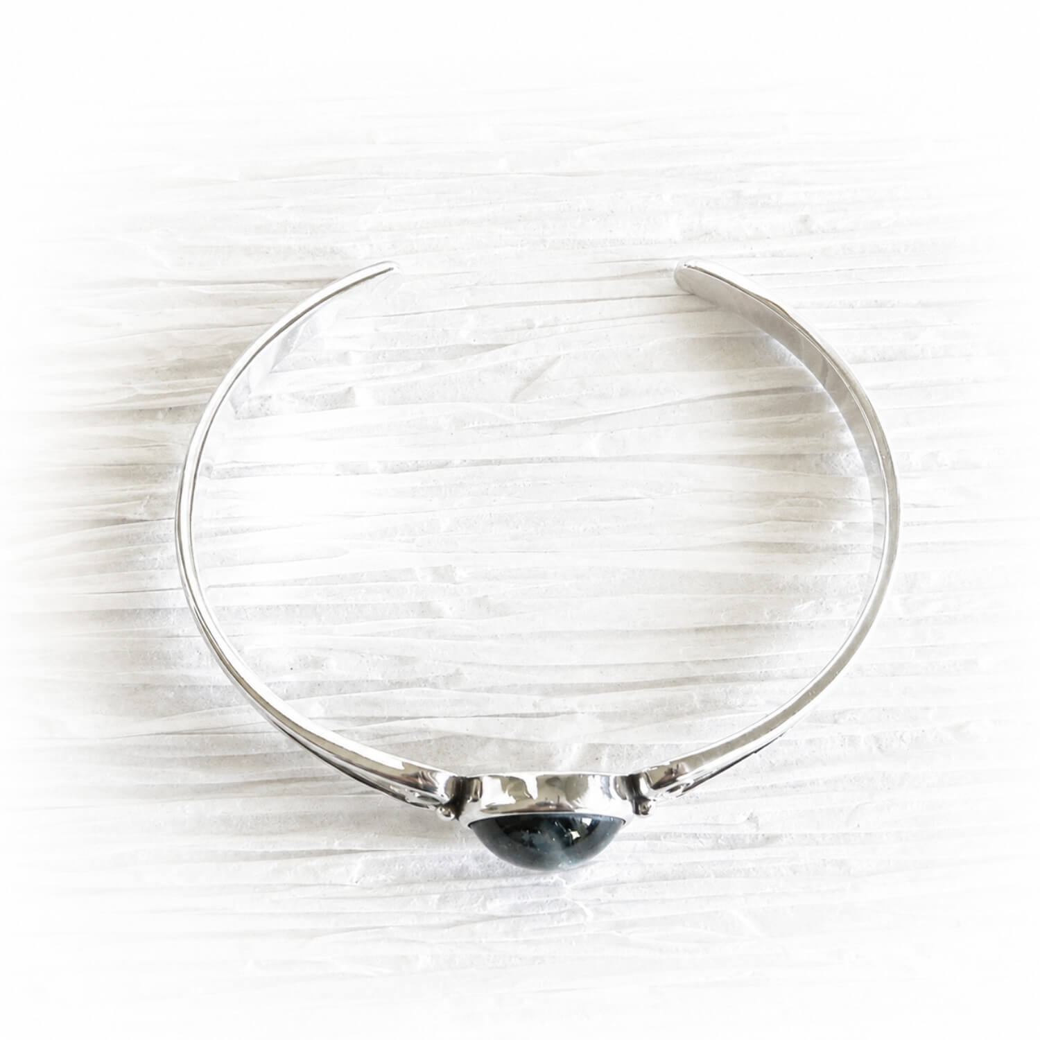Sterling silver cuff bracelet featuring handcrafted memorial glass with cremation ashes sealed within the glass
