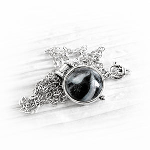Dainty sterling silver memorial necklace with a black and white hand blown ash infused glass gem