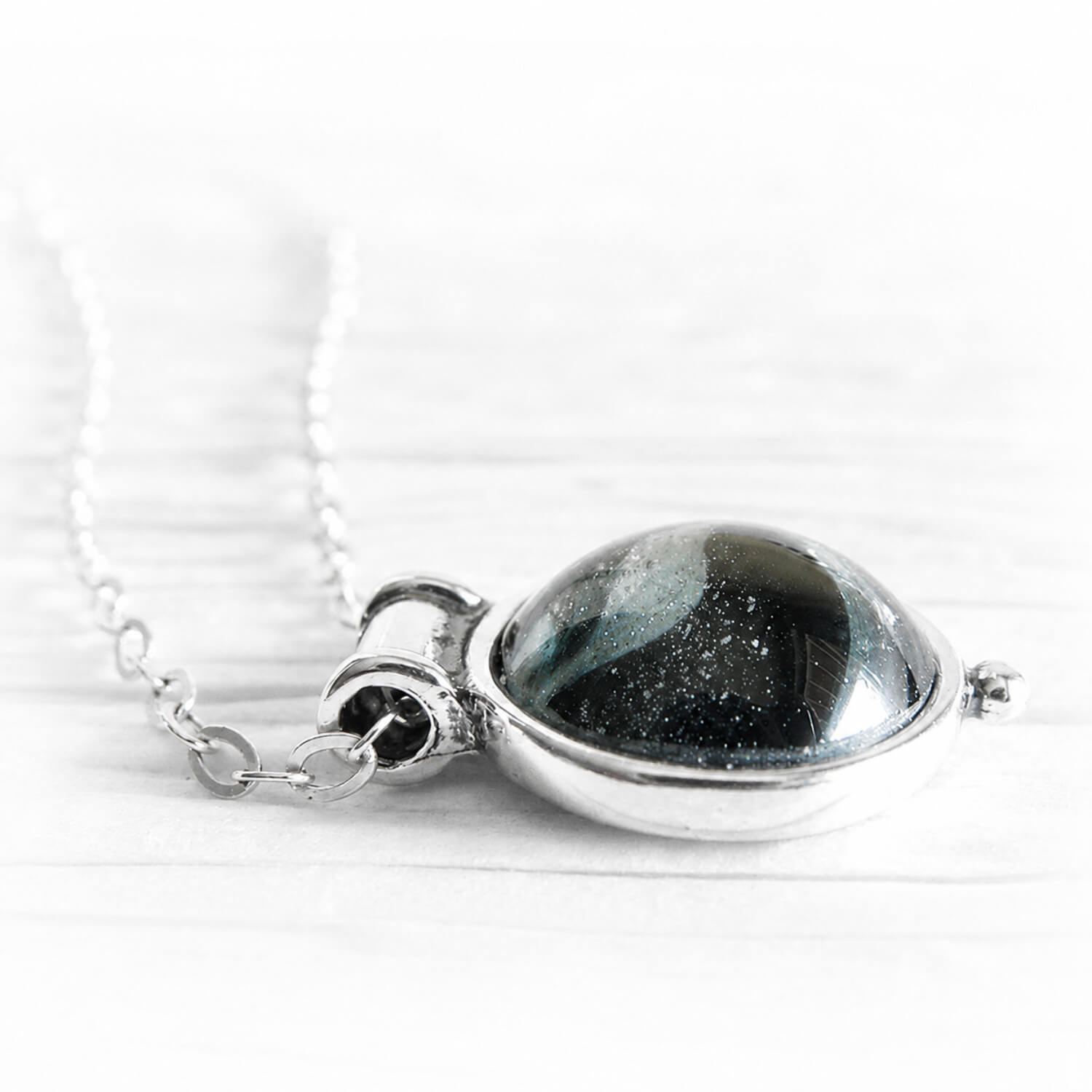 Dainty sterling silver pendant with a handmade glass gem stone made with ashes suspended within the glass