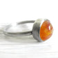 Handcrafted keepsake ring incorporating ashes in orange hand blown glass set in sterling silver