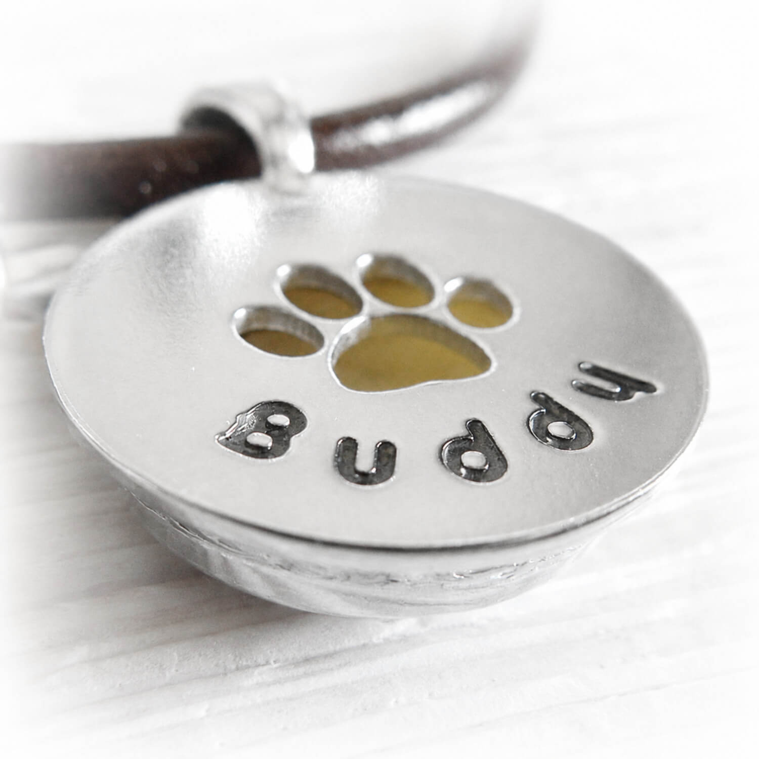 Sterling silver pendant with paw print and personalized 'Buddy' engraving