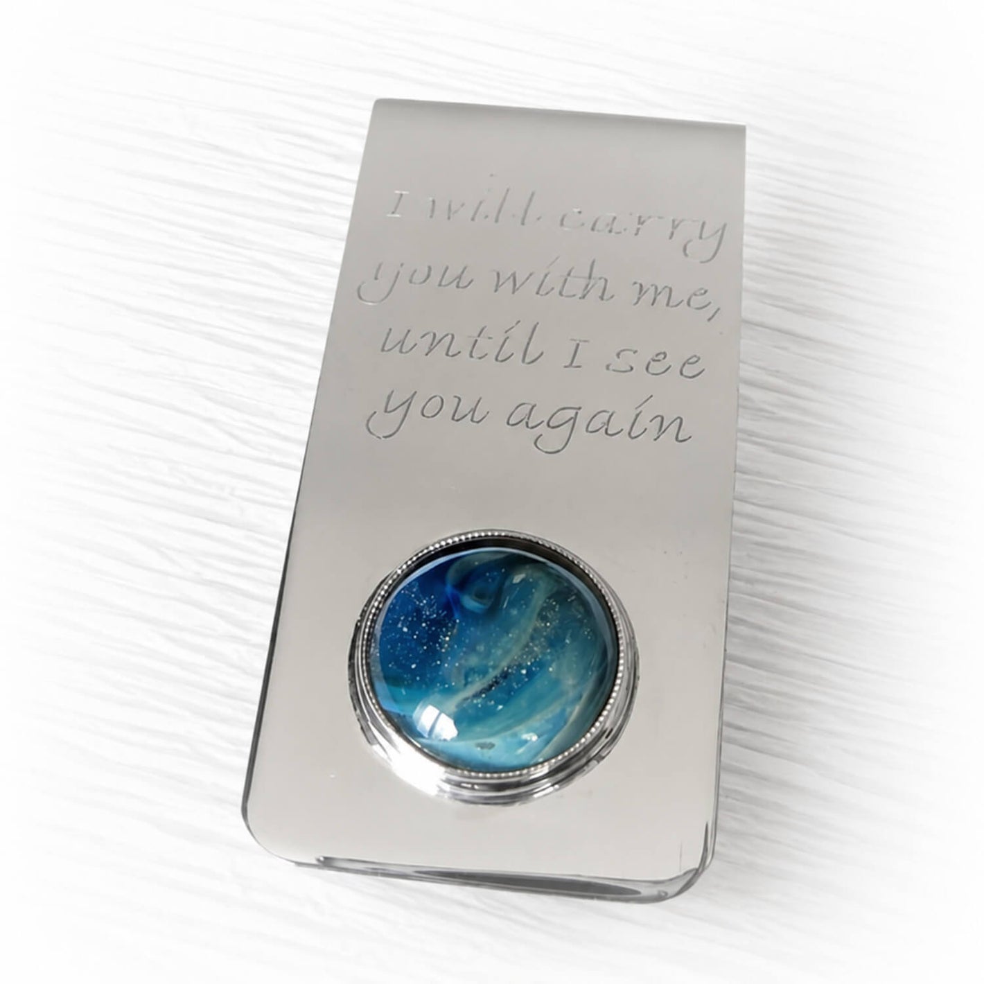 Handmade sterling silver money clip showcasing a hand blown glass cabochon with ashes suspended within the glass and customized engraving 