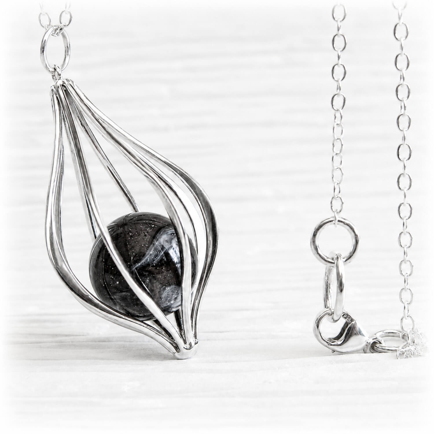 Sterling silver  pendant with a black flamework marble infused with a loved ones ashes