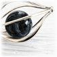 Hand blown glass cremation marble in a sterling silver cage pendant