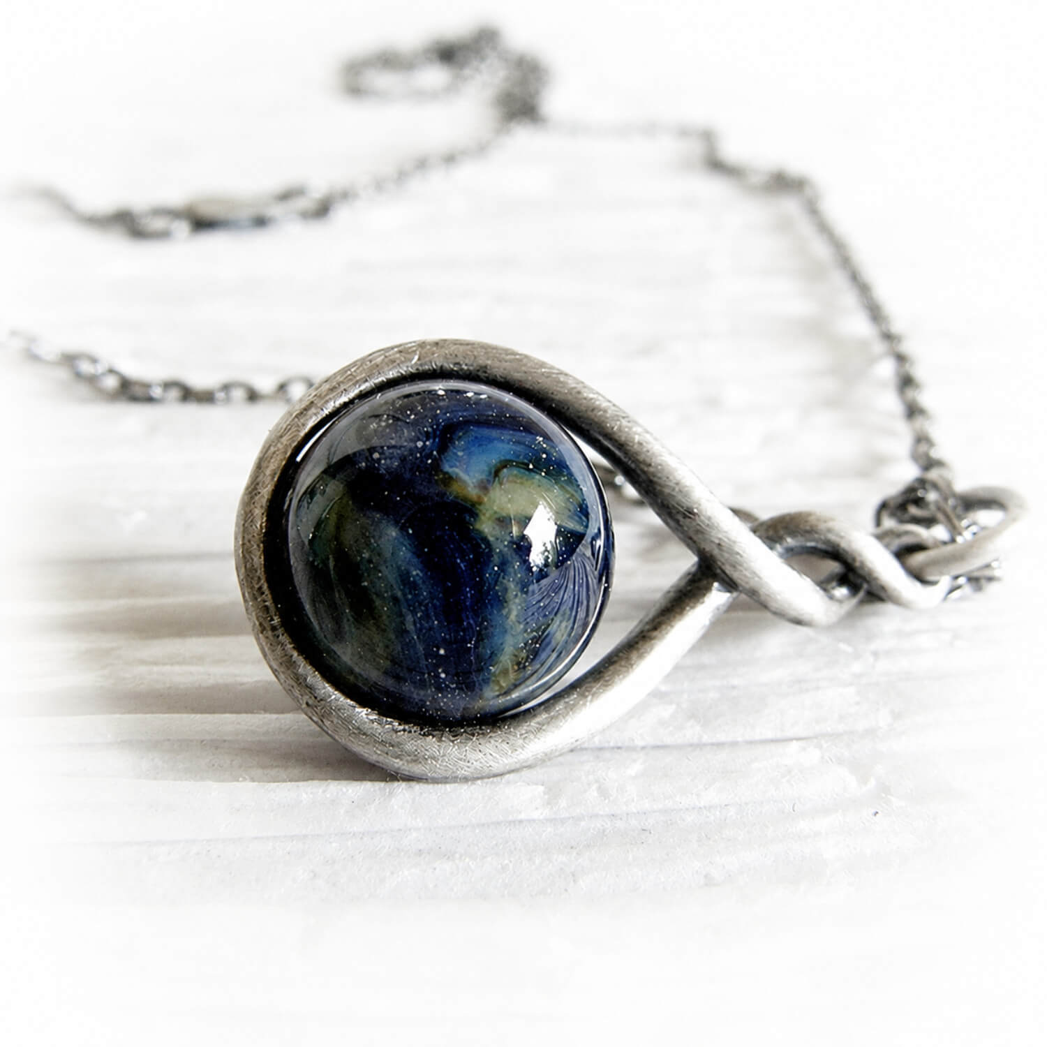 Antiqued sterling silver remembrance necklace together with a dark blue glass cremation marble 