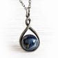 Antiqued sterling silver necklace with a blue cremation marbled pendant in an intricate metal setting 