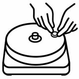 Black and white line art illustration of a tabletop rotary grinder with a hand placing a small round object onto the rotating disc.