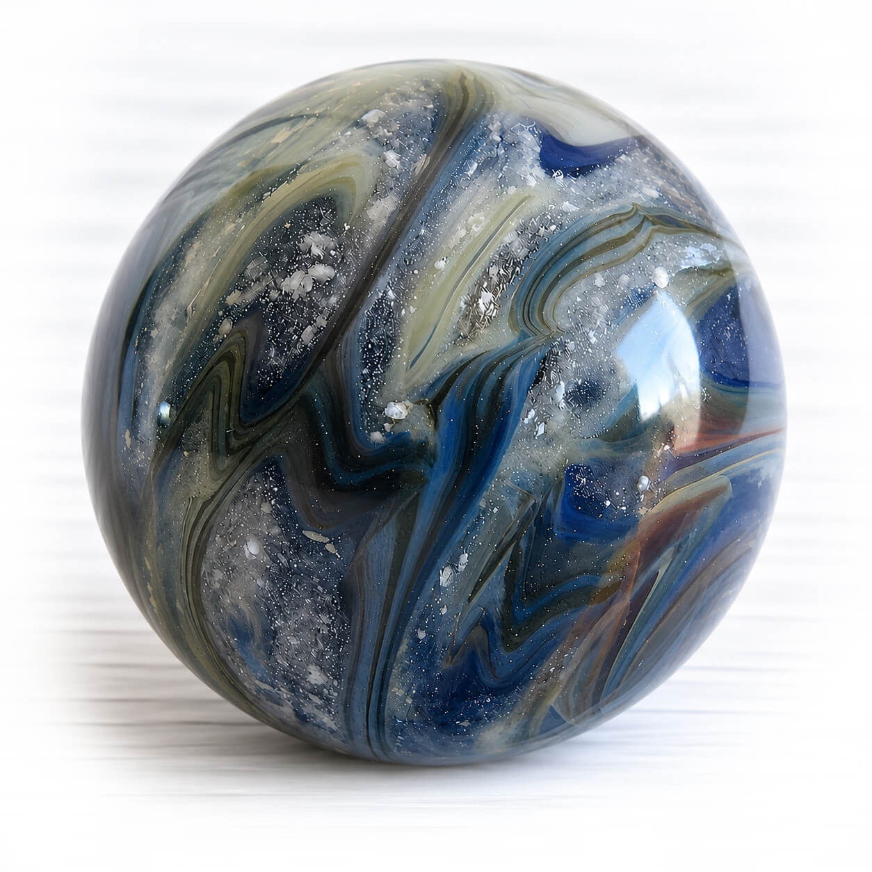 Large memorial marble made with blue lampworked glass hand crafted showing floating ashes within the glass
